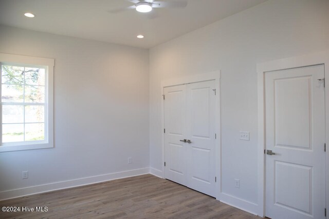 unfurnished bedroom featuring hardwood / wood-style flooring and ceiling fan