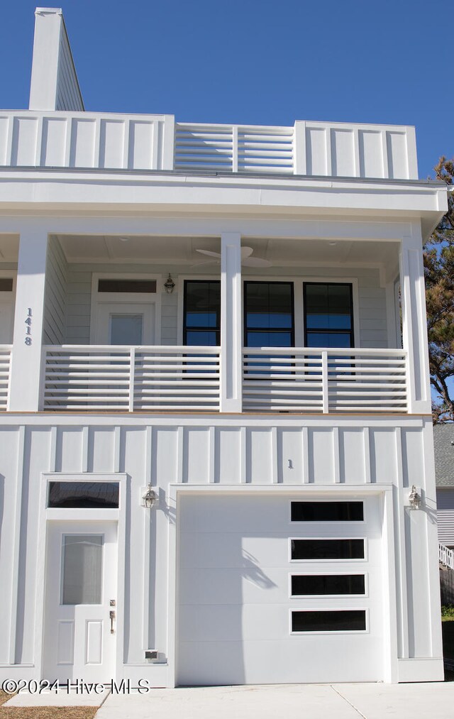 view of front of property featuring a balcony and a garage