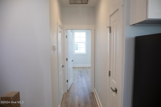 corridor with light wood-type flooring