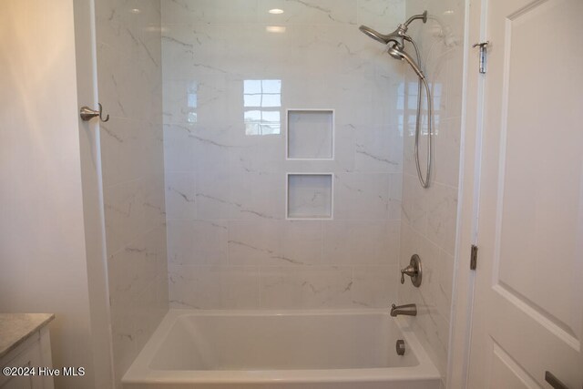 bathroom featuring vanity and tiled shower / bath combo