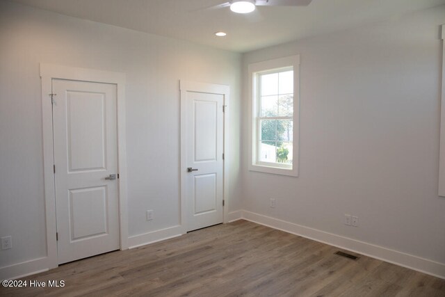 unfurnished room featuring ceiling fan and wood-type flooring