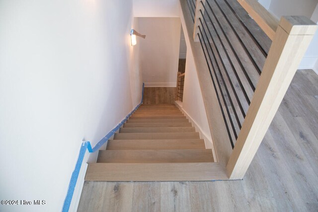 staircase with wood-type flooring