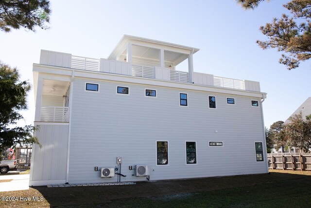 view of side of property with a balcony and ac unit