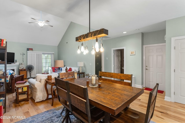 dining room with ceiling fan, light hardwood / wood-style flooring, and lofted ceiling