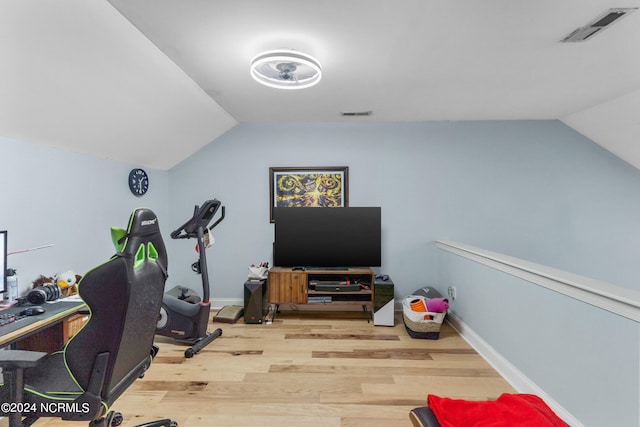 home office featuring hardwood / wood-style floors and lofted ceiling