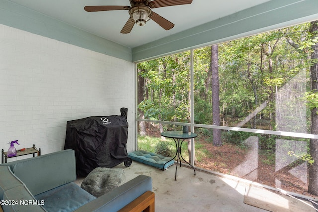 unfurnished sunroom with ceiling fan