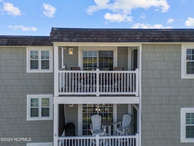 back of property featuring a balcony