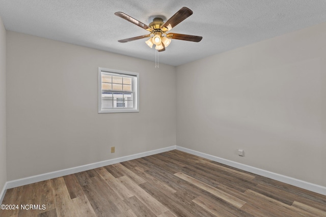 spare room with ceiling fan, hardwood / wood-style flooring, and a textured ceiling