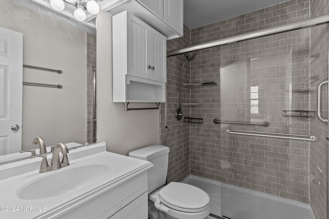 bathroom with walk in shower, vanity, and toilet