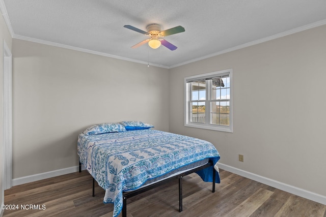 bedroom featuring a textured ceiling, wood-type flooring, crown molding, and ceiling fan