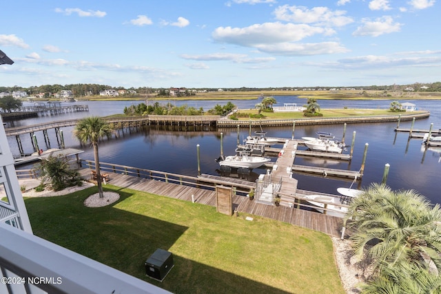 view of dock featuring a lawn and a water view