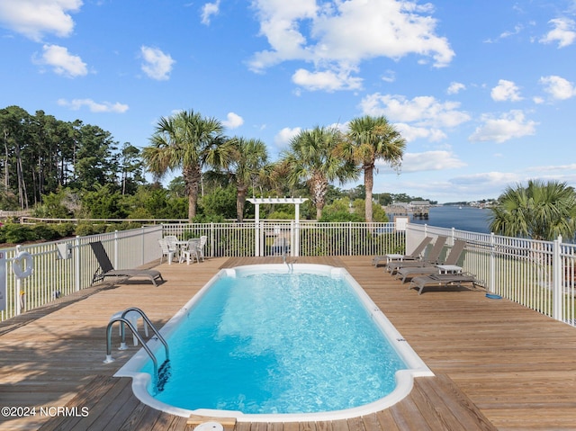 view of pool featuring a deck with water view