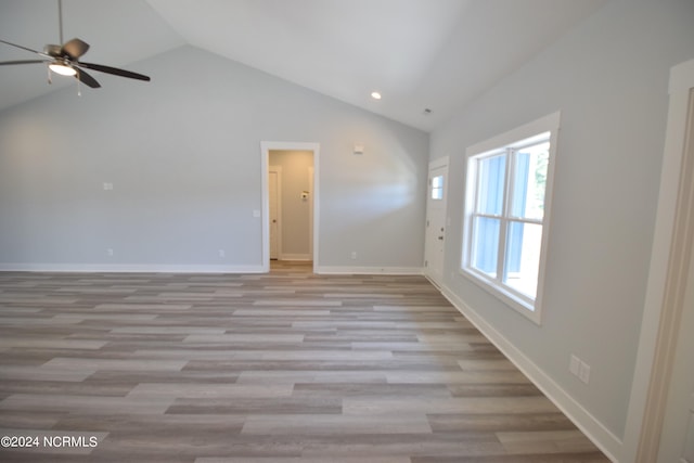 spare room featuring ceiling fan, light hardwood / wood-style flooring, and vaulted ceiling