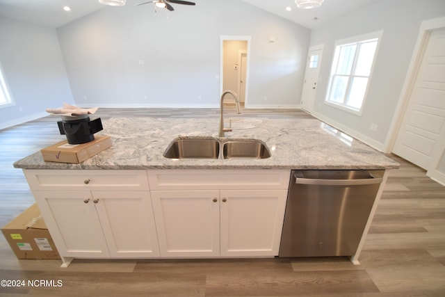 kitchen featuring white cabinets, dishwasher, sink, and vaulted ceiling