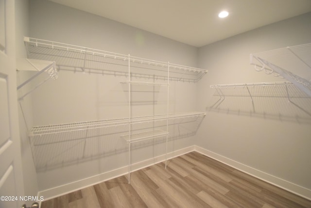 spacious closet featuring hardwood / wood-style floors