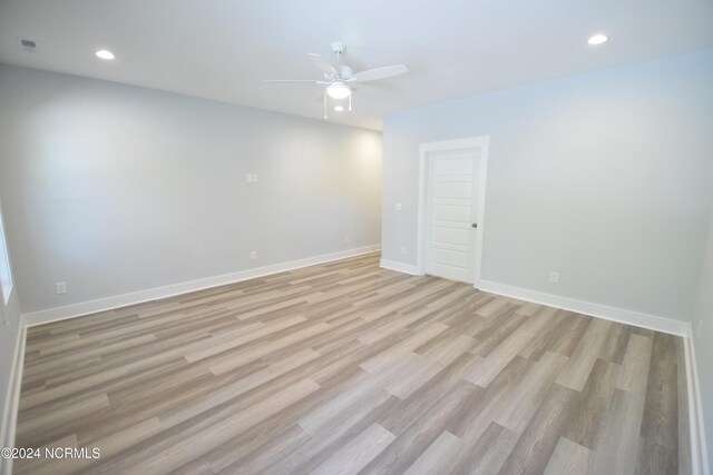 spare room featuring ceiling fan and light wood-type flooring