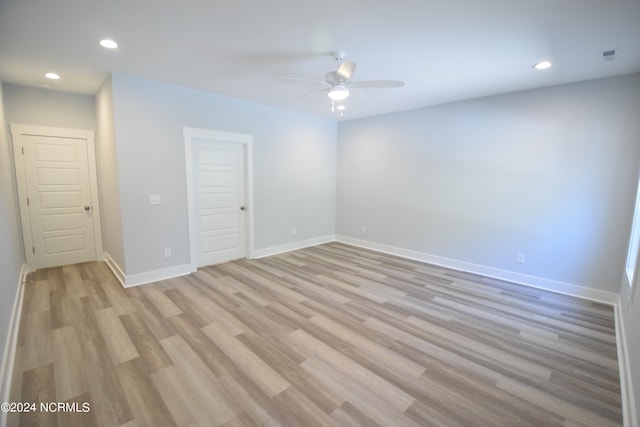 empty room featuring ceiling fan and light wood-type flooring