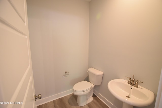 bathroom featuring hardwood / wood-style floors, toilet, and sink