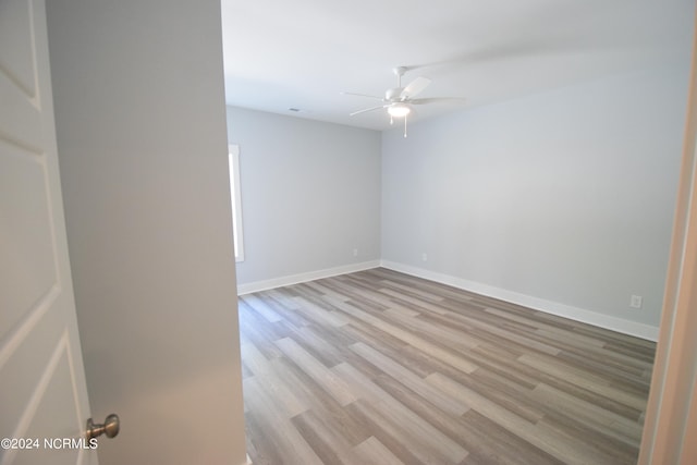 spare room with light hardwood / wood-style floors and ceiling fan