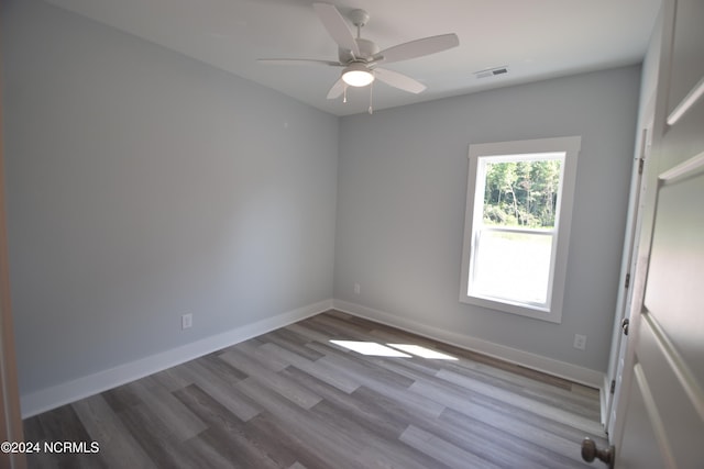 spare room featuring ceiling fan and light hardwood / wood-style floors