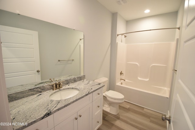 full bathroom with wood-type flooring, shower / bath combination, vanity, and toilet