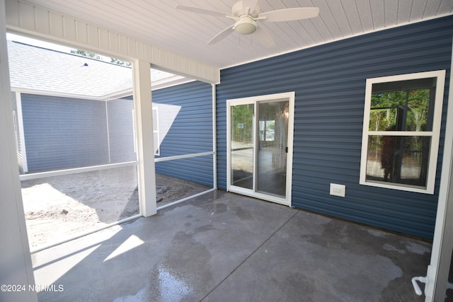 unfurnished sunroom with ceiling fan and plenty of natural light