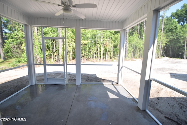 unfurnished sunroom with ceiling fan