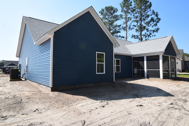 back of house with a sunroom and central AC unit