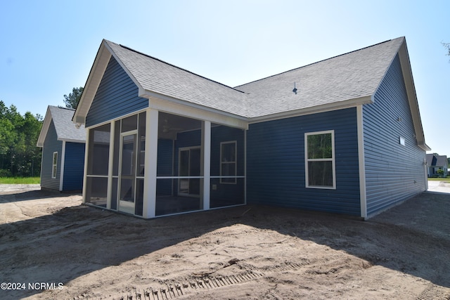 rear view of property with a sunroom