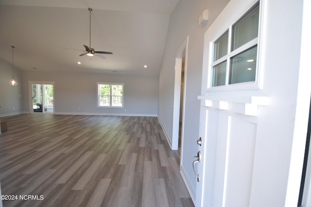 interior space with ceiling fan, hardwood / wood-style flooring, and lofted ceiling