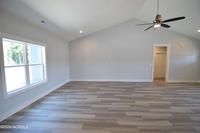 unfurnished room featuring ceiling fan, lofted ceiling, and light wood-type flooring