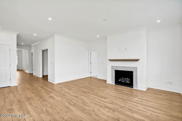 unfurnished living room with light wood finished floors, recessed lighting, a fireplace, and baseboards