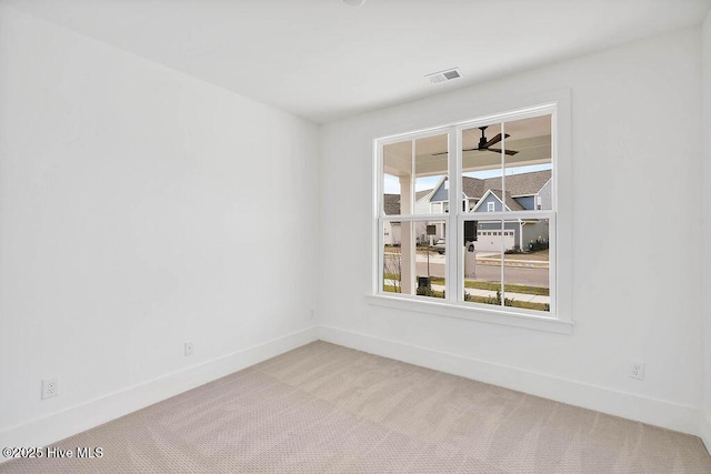 spare room with visible vents, ceiling fan, baseboards, and carpet floors