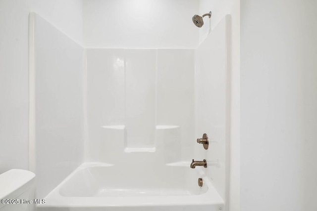 bathroom with toilet and shower / bathtub combination