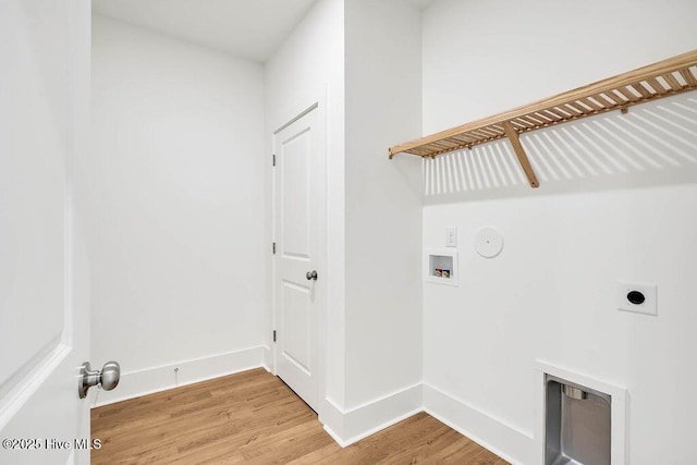 clothes washing area featuring wood finished floors, baseboards, hookup for an electric dryer, laundry area, and washer hookup