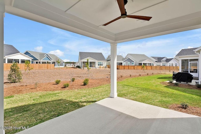 view of yard featuring a residential view, a patio, a ceiling fan, and fence