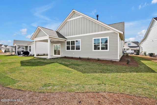 back of property featuring a patio area, board and batten siding, and a yard