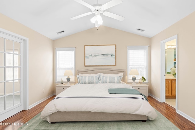 bedroom featuring visible vents, wood finished floors, and vaulted ceiling