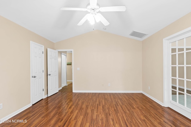 spare room featuring ceiling fan, visible vents, vaulted ceiling, wood finished floors, and baseboards