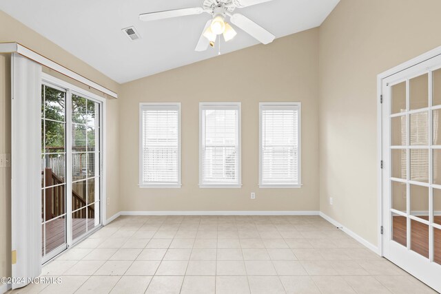 unfurnished room with light tile patterned floors, vaulted ceiling, and ceiling fan