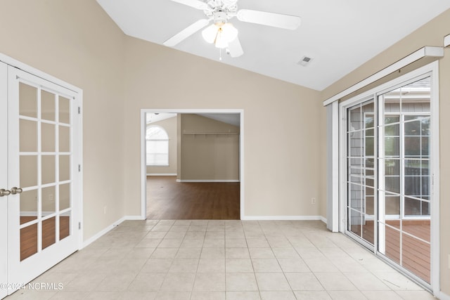 spare room featuring ceiling fan, light hardwood / wood-style flooring, and lofted ceiling