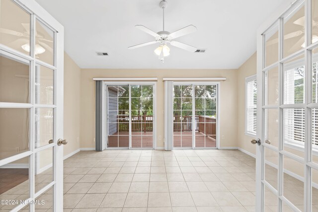 interior space with ceiling fan, light tile patterned floors, french doors, and lofted ceiling