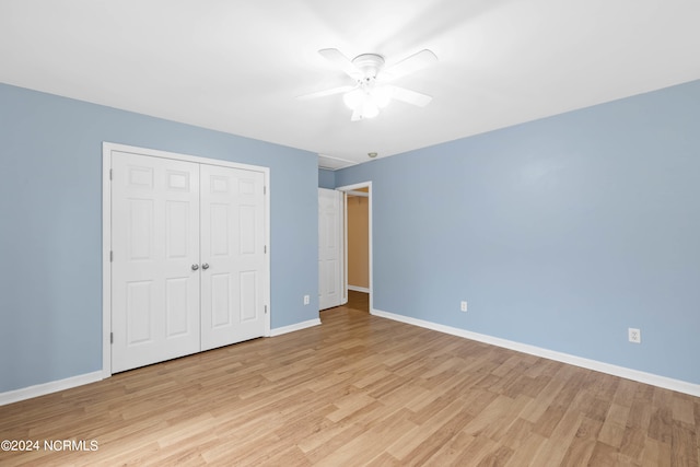 unfurnished bedroom with ceiling fan, light hardwood / wood-style flooring, and a closet