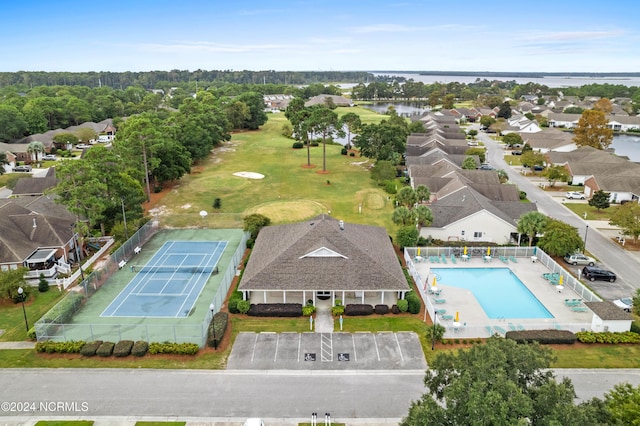 birds eye view of property with a water view, a residential view, and golf course view