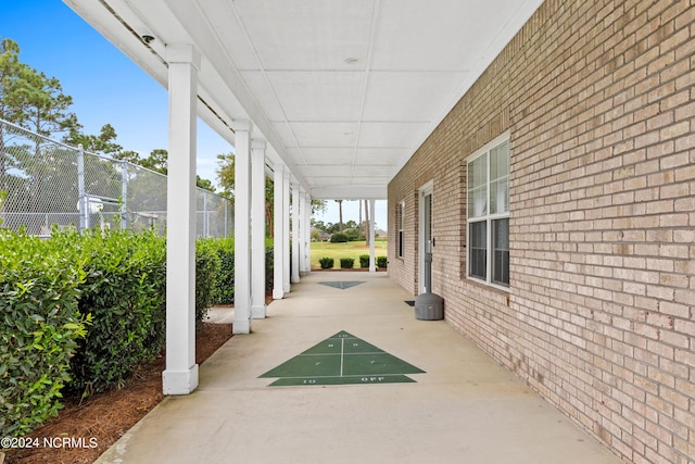 view of patio with fence and shuffleboard