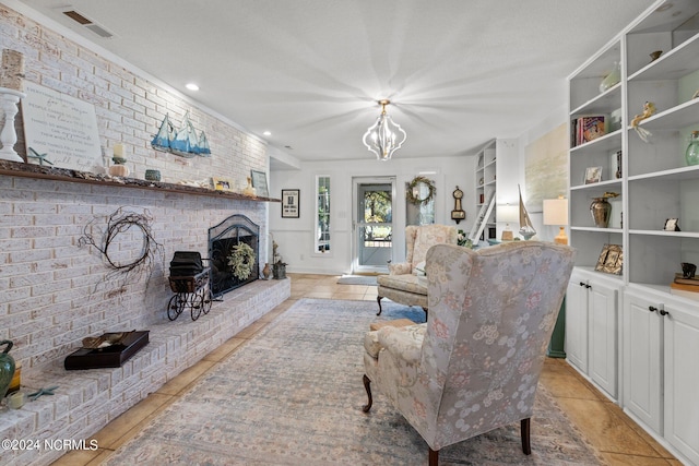 living room featuring a fireplace, light tile patterned flooring, a textured ceiling, and an inviting chandelier