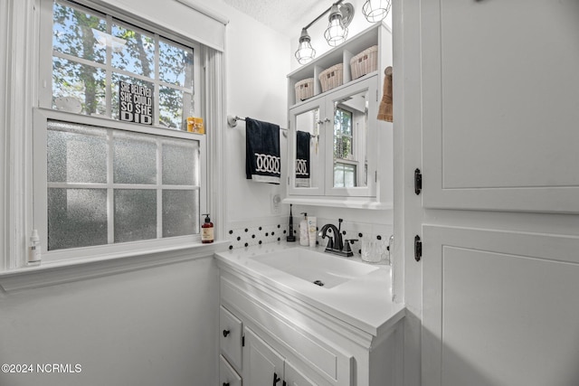 bathroom featuring vanity and a textured ceiling