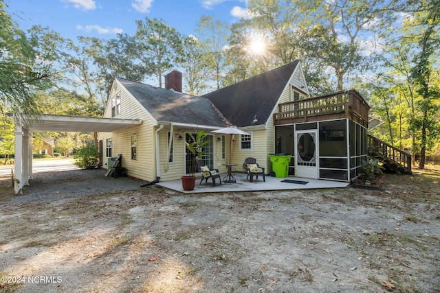 back of property featuring a patio area and a sunroom