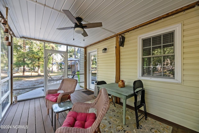 sunroom featuring ceiling fan and wooden ceiling