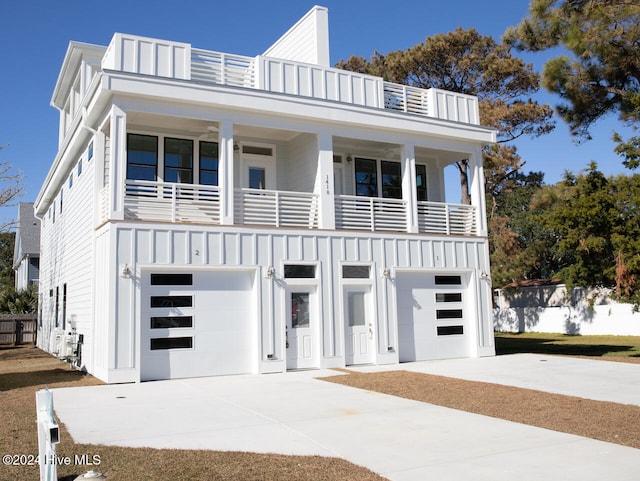 view of front of property featuring a balcony and a garage